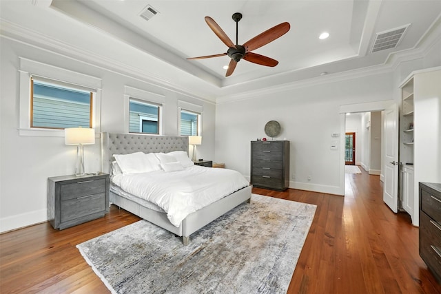 829 Ralfallen St, Houston, TX 77008 - bedroom featuring a raised ceiling, wood finished floors, ornamental molding, recessed lighting, and a ceiling fan