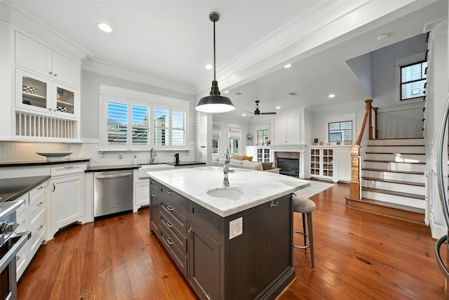829 Ralfallen St, Houston, TX 77008 - kitchen featuring dishwasher, a glass covered fireplace, ceiling fan, white cabinets, and recessed lighting