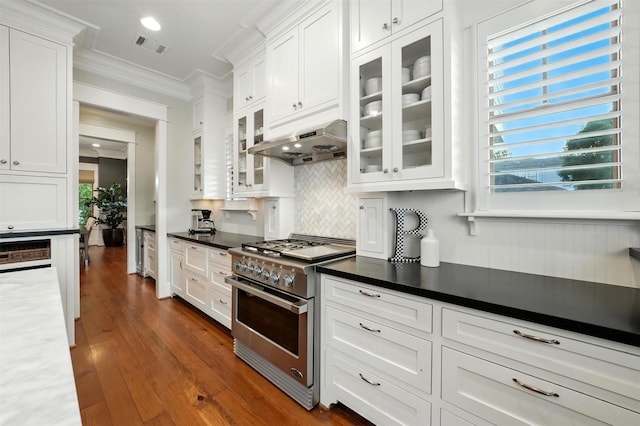 829 Ralfallen St, Houston, TX 77008 - kitchen featuring stainless steel range, ornamental molding, range hood, white cabinets, and backsplash