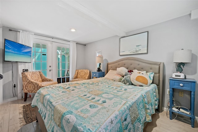 1805 19th St, Galveston, TX 77550 - bedroom with beamed ceiling, wood finished floors, french doors, and recessed lighting