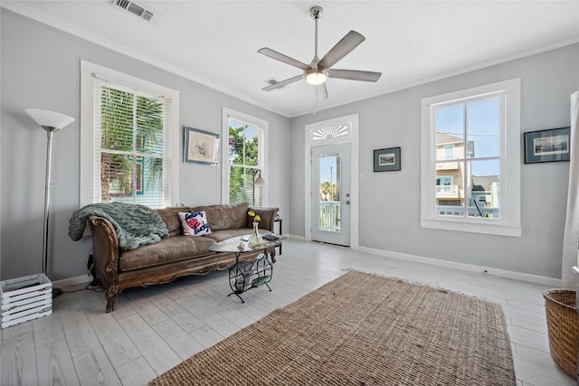 1805 19th St, Galveston, TX 77550 - living room with crown molding, plenty of natural light, light wood-style floors, and a ceiling fan