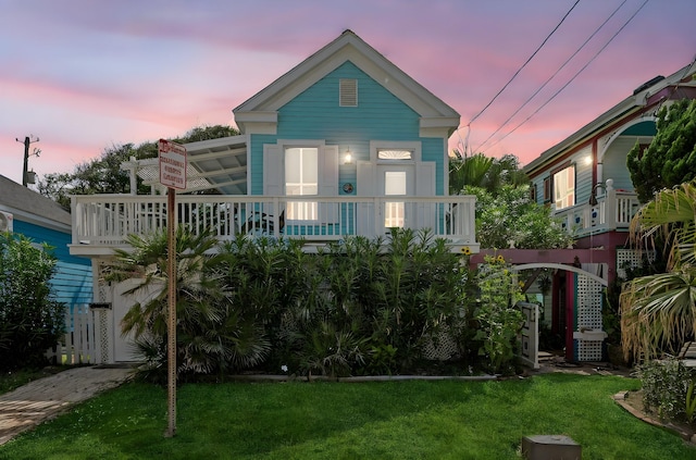 1805 19th St, Galveston, TX 77550 - view of front facade with a lawn and a balcony