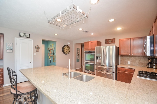22218 Woodseem Ct, Katy, TX 77449 - kitchen featuring stainless steel appliances, recessed lighting, light stone countertops, backsplash, and a breakfast bar
