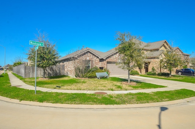 22218 Woodseem Ct, Katy, TX 77449 - view of front of property with driveway, a garage, and brick siding