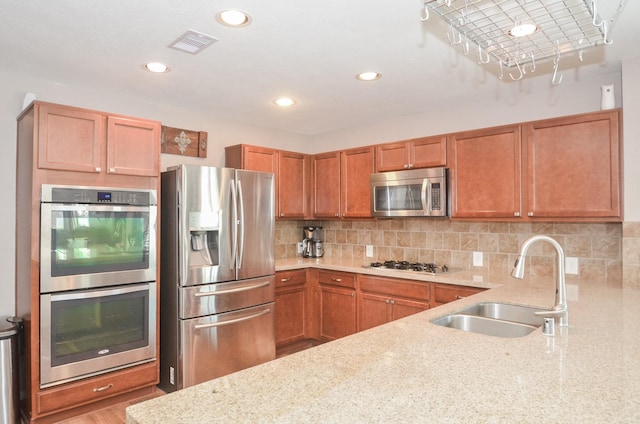 22218 Woodseem Ct, Katy, TX 77449 - kitchen featuring stainless steel appliances, decorative backsplash, light stone countertops, and recessed lighting