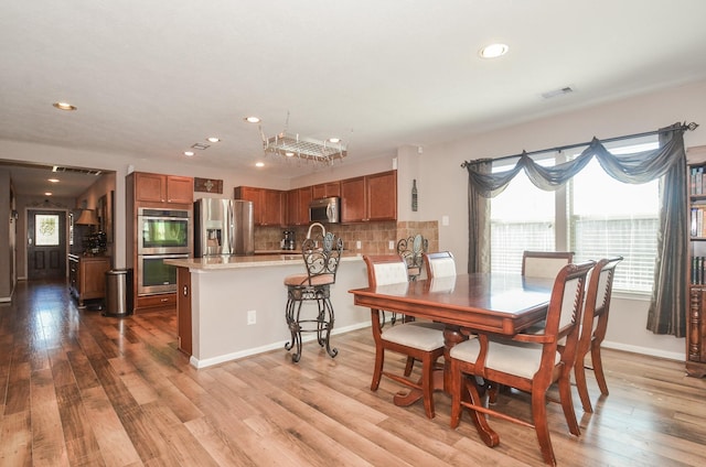22218 Woodseem Ct, Katy, TX 77449 - dining room with plenty of natural light, recessed lighting, and wood finished floors