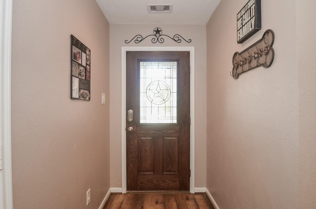 22218 Woodseem Ct, Katy, TX 77449 - doorway with dark wood finished floors and baseboards