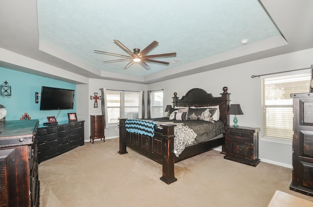 22218 Woodseem Ct, Katy, TX 77449 - bedroom featuring a raised ceiling, light carpet, and ceiling fan