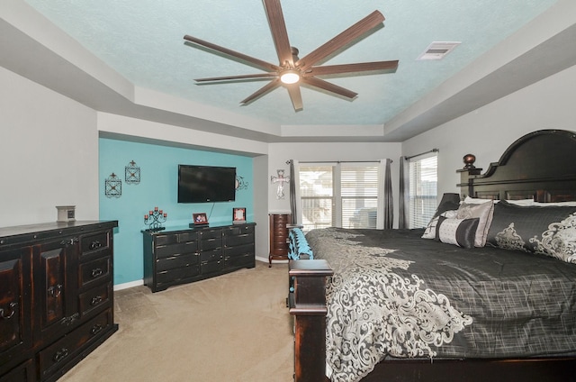 22218 Woodseem Ct, Katy, TX 77449 - bedroom featuring light carpet, a raised ceiling, and ceiling fan