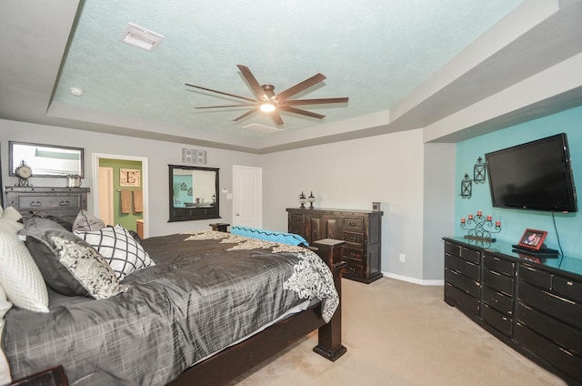 22218 Woodseem Ct, Katy, TX 77449 - carpeted bedroom featuring a tray ceiling, a ceiling fan, and a textured ceiling