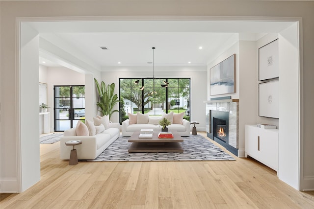 4618 Devon St, Houston, TX 77027 - living area featuring plenty of natural light, light wood-type flooring, a glass covered fireplace, ornamental molding, and recessed lighting