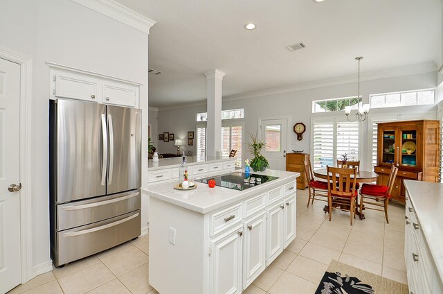 2014 Shadow Forest Dr, Katy, TX 77494 - kitchen with freestanding refrigerator, black electric cooktop, light tile patterned floors, ornamental molding, and white cabinets