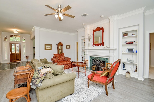 2014 Shadow Forest Dr, Katy, TX 77494 - living area with built in shelves, wood finished floors, crown molding, ceiling fan, and a fireplace
