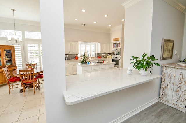 2014 Shadow Forest Dr, Katy, TX 77494 - kitchen with double oven, crown molding, a chandelier, backsplash, and a peninsula