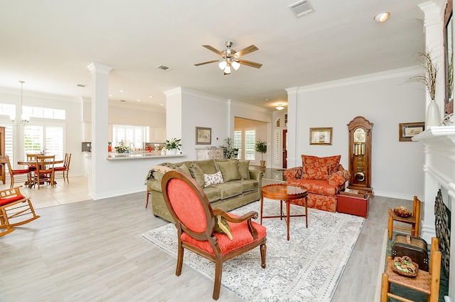 2014 Shadow Forest Dr, Katy, TX 77494 - living area featuring crown molding, a ceiling fan, a fireplace, light wood-style floors, and ornate columns