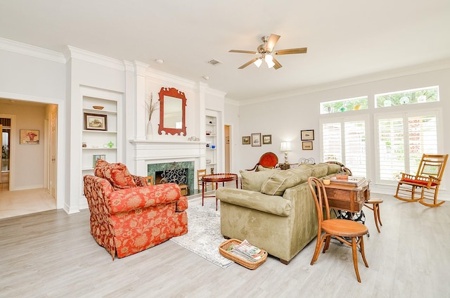 2014 Shadow Forest Dr, Katy, TX 77494 - living area with ornamental molding, ceiling fan, built in features, light wood-type flooring, and a fireplace