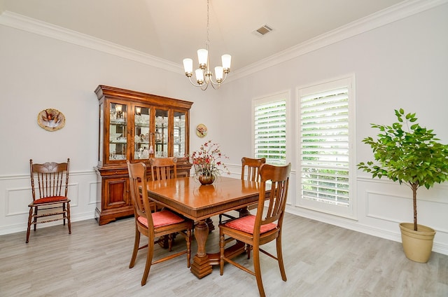 2014 Shadow Forest Dr, Katy, TX 77494 - dining area with a chandelier, ornamental molding, light wood-type flooring, a wainscoted wall, and a decorative wall