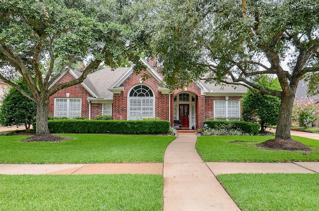 2014 Shadow Forest Dr, Katy, TX 77494 - view of front facade featuring brick siding, a front yard, and a shingled roof