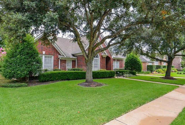 2014 Shadow Forest Dr, Katy, TX 77494 - view of property hidden behind natural elements featuring brick siding and a front lawn