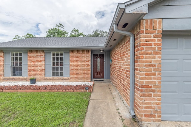 7307 Sunlight Ln, Houston, TX 77095 - view of exterior entry featuring brick siding, a garage, and roof with shingles