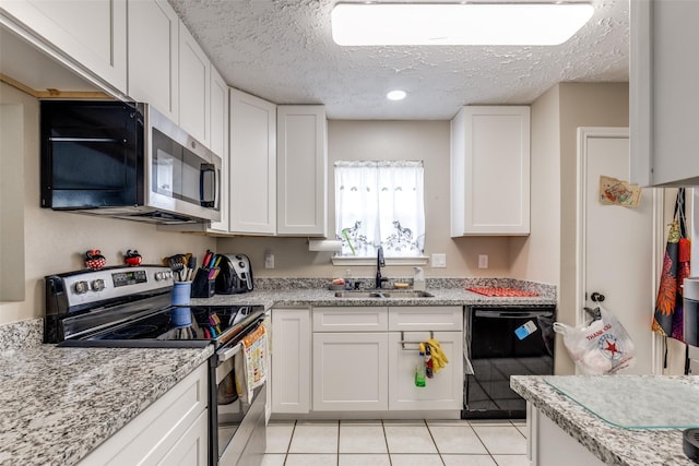7307 Sunlight Ln, Houston, TX 77095 - kitchen with stainless steel appliances, a textured ceiling, white cabinetry, light tile patterned floors, and light stone countertops