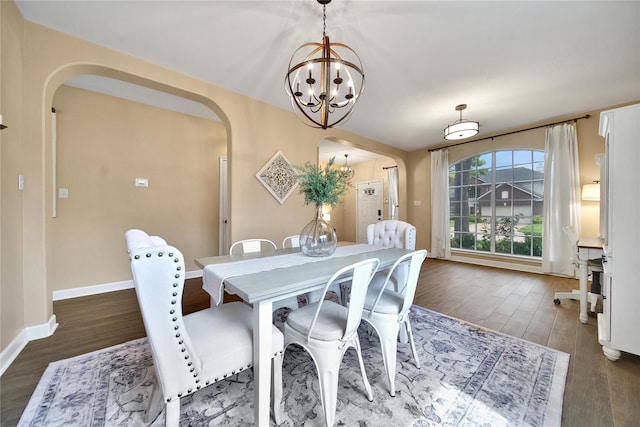 18219 Water Mill Dr, Cypress, TX 77429 - dining room featuring arched walkways, a chandelier, and dark wood-style flooring