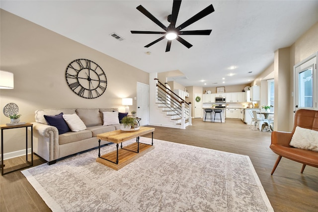 18219 Water Mill Dr, Cypress, TX 77429 - living room with ceiling fan, stairway, and wood finished floors