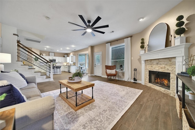 18219 Water Mill Dr, Cypress, TX 77429 - living room with ceiling fan, a fireplace, stairway, wood finished floors, and recessed lighting