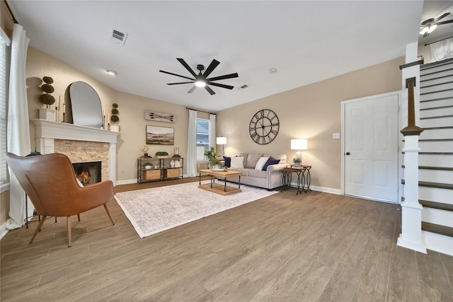 18219 Water Mill Dr, Cypress, TX 77429 - living area featuring a ceiling fan, a stone fireplace, wood finished floors, and stairway