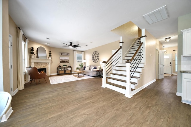 18219 Water Mill Dr, Cypress, TX 77429 - living area with a ceiling fan, stairway, wood finished floors, and a fireplace