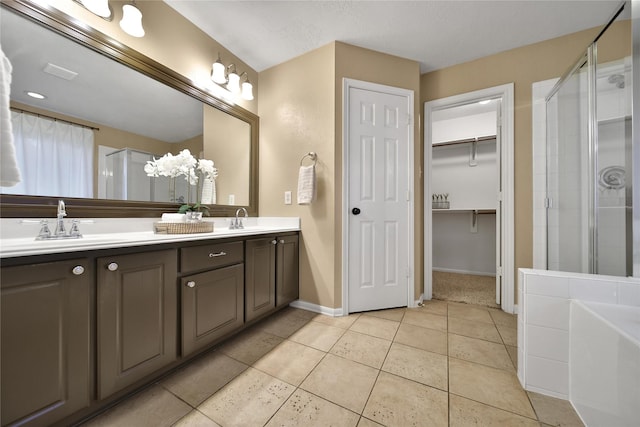 18219 Water Mill Dr, Cypress, TX 77429 - full bath with a stall shower, double vanity, tile patterned flooring, a walk in closet, and a tub to relax in