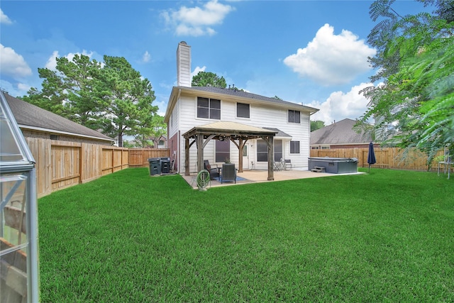 18219 Water Mill Dr, Cypress, TX 77429 - back of property featuring a hot tub, a gazebo, a patio area, and a fenced backyard