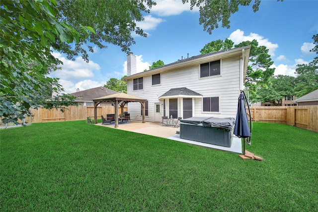 18219 Water Mill Dr, Cypress, TX 77429 - rear view of house featuring a gazebo, a hot tub, a patio area, a chimney, and a fenced backyard