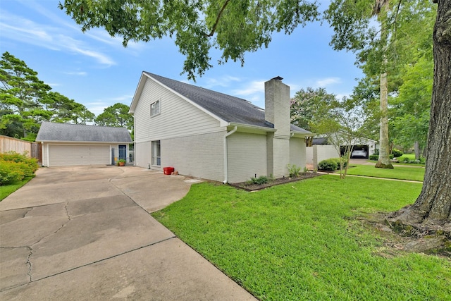 3510 Ledgestone Dr, Houston, TX 77059 - view of home's exterior with a chimney, a lawn, brick siding, concrete driveway, and an outdoor structure