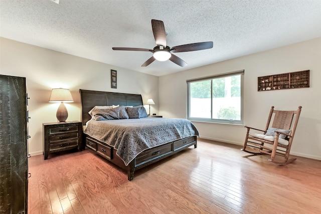 3510 Ledgestone Dr, Houston, TX 77059 - bedroom featuring hardwood / wood-style flooring, a textured ceiling, and a ceiling fan