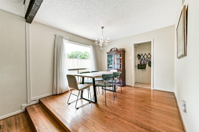 3510 Ledgestone Dr, Houston, TX 77059 - dining room with a textured ceiling, a chandelier, and light wood-style flooring