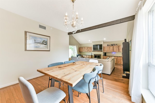 3510 Ledgestone Dr, Houston, TX 77059 - dining room featuring a chandelier, light wood-type flooring, and a fireplace