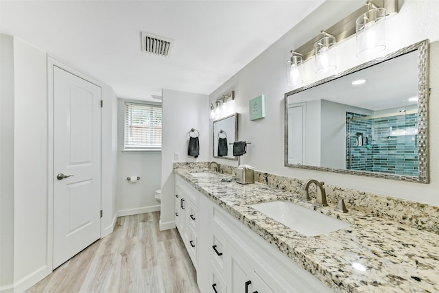3510 Ledgestone Dr, Houston, TX 77059 - full bath featuring double vanity, a tile shower, and wood finished floors