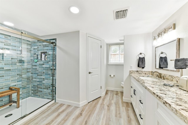 3510 Ledgestone Dr, Houston, TX 77059 - bathroom with a shower stall, vanity, wood finished floors, and recessed lighting