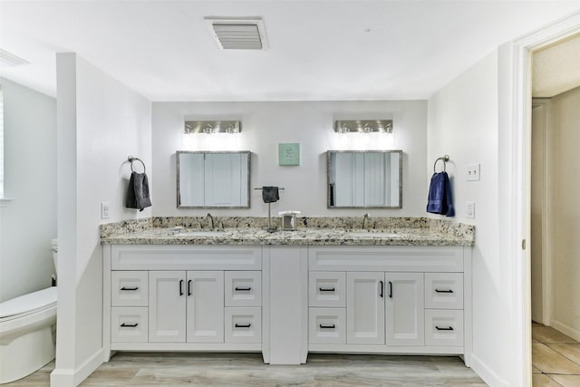 3510 Ledgestone Dr, Houston, TX 77059 - full bathroom featuring double vanity and wood finished floors