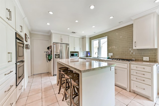 3510 Ledgestone Dr, Houston, TX 77059 - kitchen with stainless steel appliances, ornamental molding, a breakfast bar, light tile patterned flooring, and backsplash