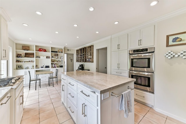 3510 Ledgestone Dr, Houston, TX 77059 - kitchen with appliances with stainless steel finishes, crown molding, light tile patterned floors, a kitchen island, and white cabinets