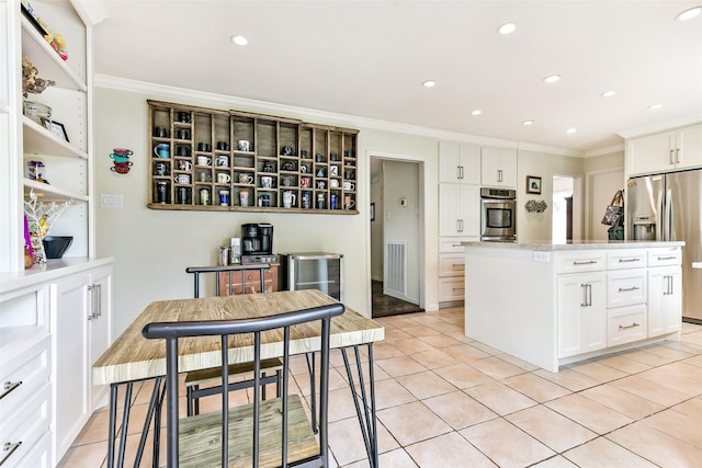 3510 Ledgestone Dr, Houston, TX 77059 - kitchen featuring appliances with stainless steel finishes, light tile patterned floors, white cabinets, ornamental molding, and recessed lighting