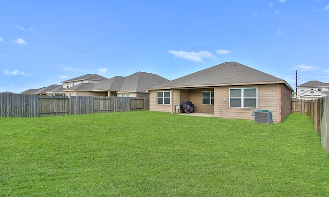 21015 Echo Manor Dr, Hockley, TX 77447 - back of property featuring a fenced backyard, a shingled roof, and a patio area