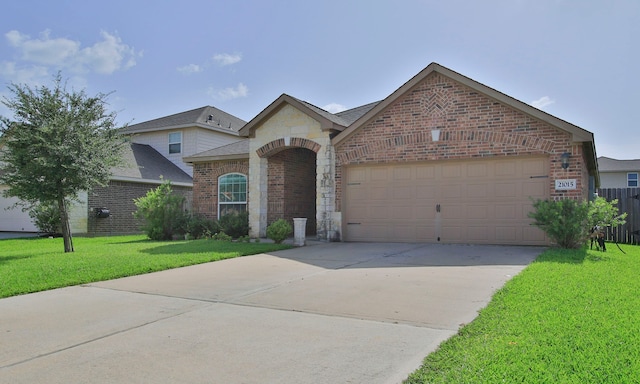 21015 Echo Manor Dr, Hockley, TX 77447 - french country style house featuring brick siding, a front lawn, a garage, driveway, and stone siding