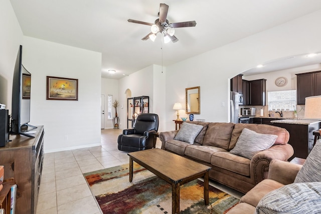 21015 Echo Manor Dr, Hockley, TX 77447 - living area featuring light tile patterned floors, ceiling fan, and arched walkways