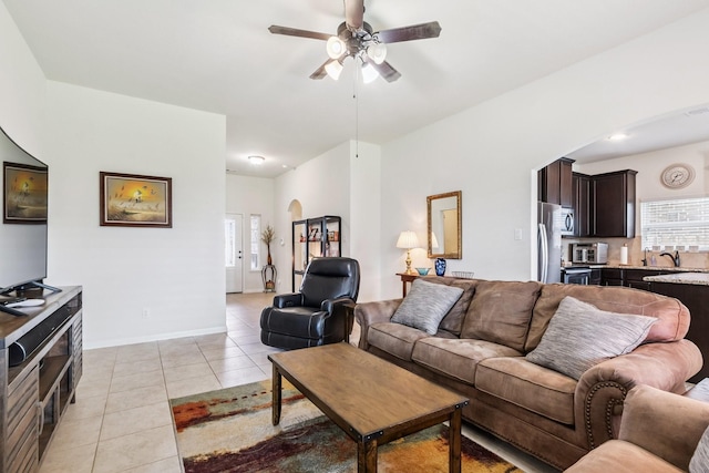 21015 Echo Manor Dr, Hockley, TX 77447 - living area with light tile patterned floors, a ceiling fan, healthy amount of natural light, and arched walkways