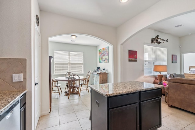 21015 Echo Manor Dr, Hockley, TX 77447 - kitchen with stainless steel dishwasher, light tile patterned flooring, open floor plan, light stone countertops, and a center island