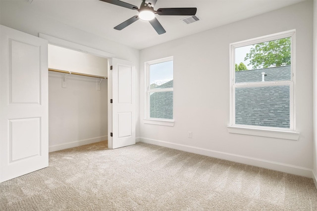 882 Prosper St, Houston, TX 77088 - unfurnished bedroom with light colored carpet, multiple windows, a closet, and a ceiling fan