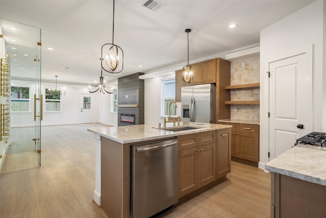 882 Prosper St, Houston, TX 77088 - kitchen featuring appliances with stainless steel finishes, light wood-style floors, a chandelier, recessed lighting, and an island with sink